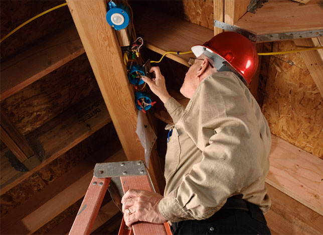 building inspector on a ladder